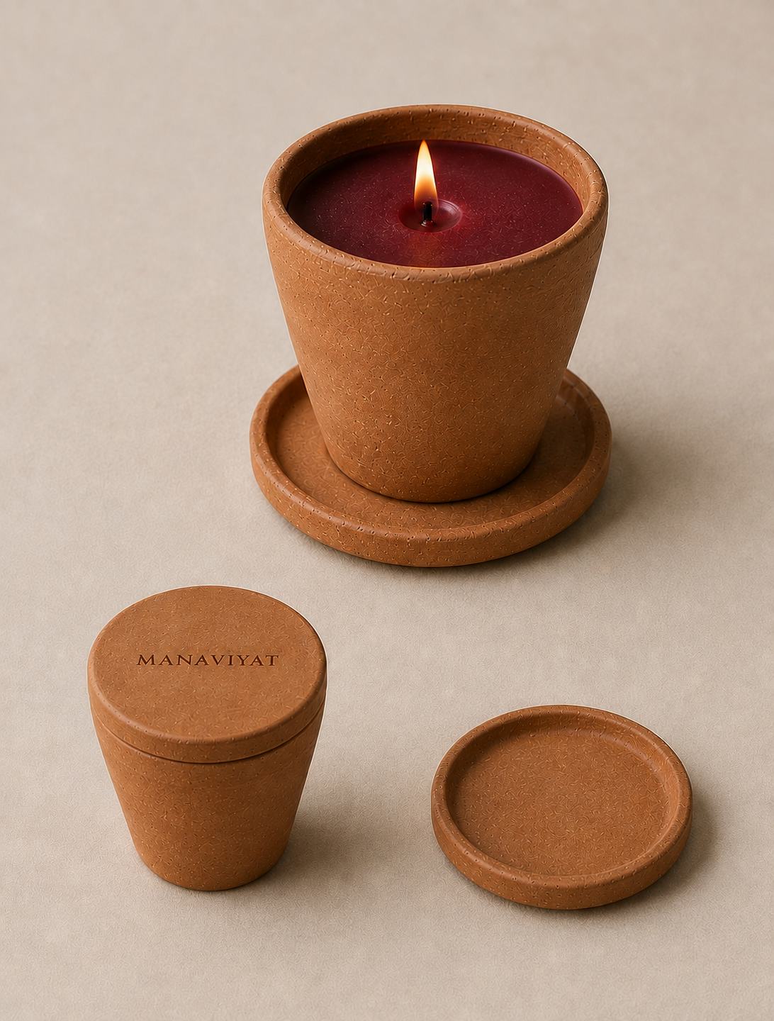 Mitti Di Khushboo, a kulhad-inspired terracotta candle with deep maroon wax, shown lit with its matching lid and coaster