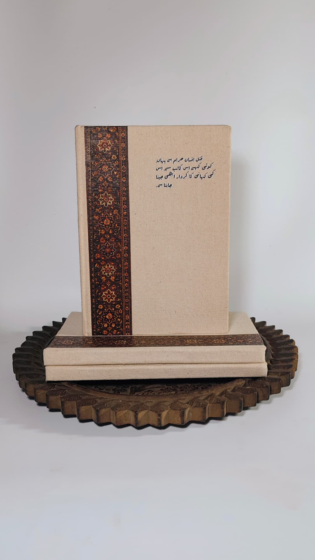 Three Kaatib diaries stacked, one standing upright to show the cover